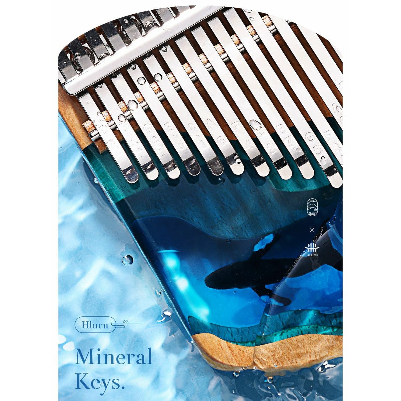 Hluru Mineral Keys kalimba with ocean design, metallic tines, and wooden base submerged in water