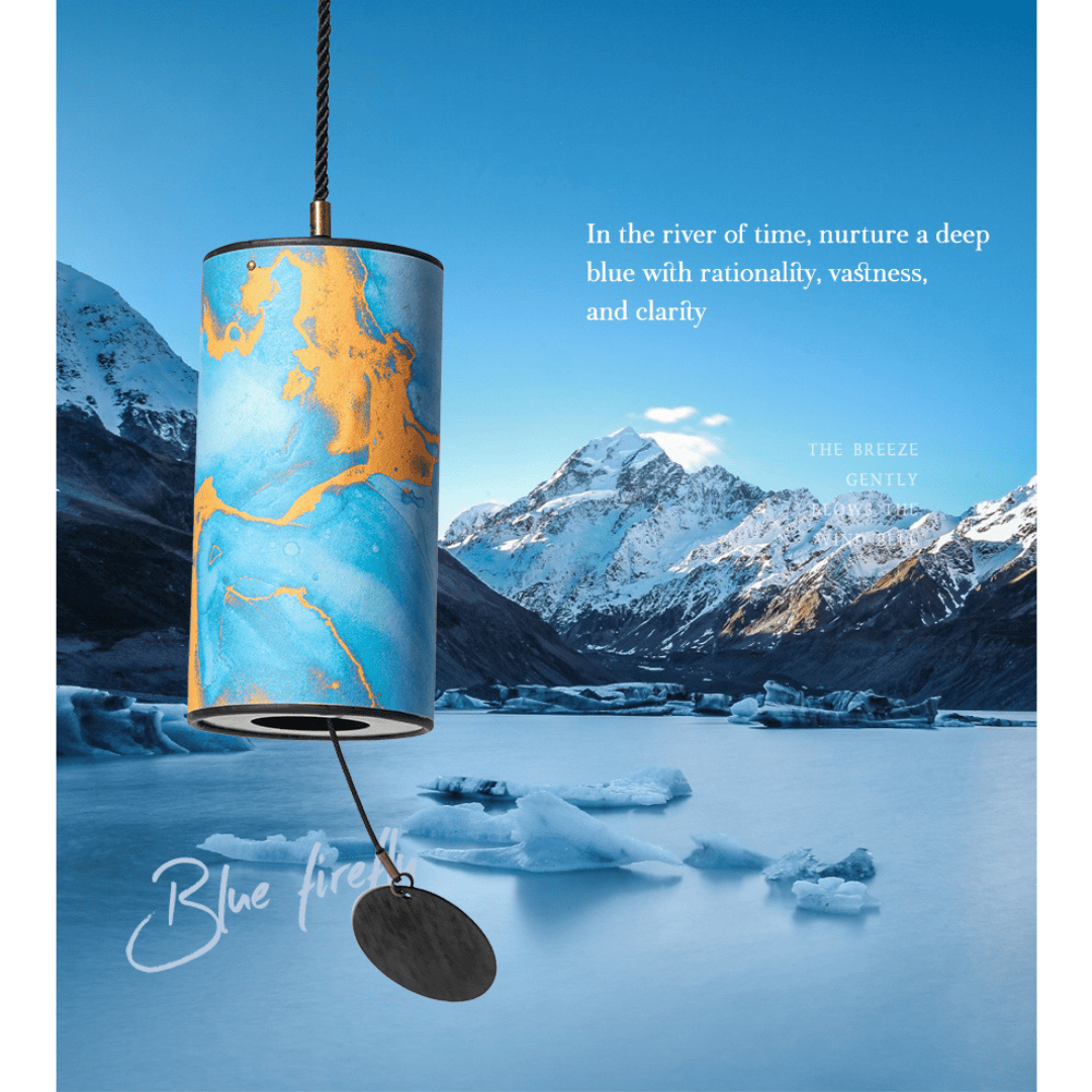 Blue and gold marbled wind chime hanging over icy lake with snowy mountains, evoking calm and clarity