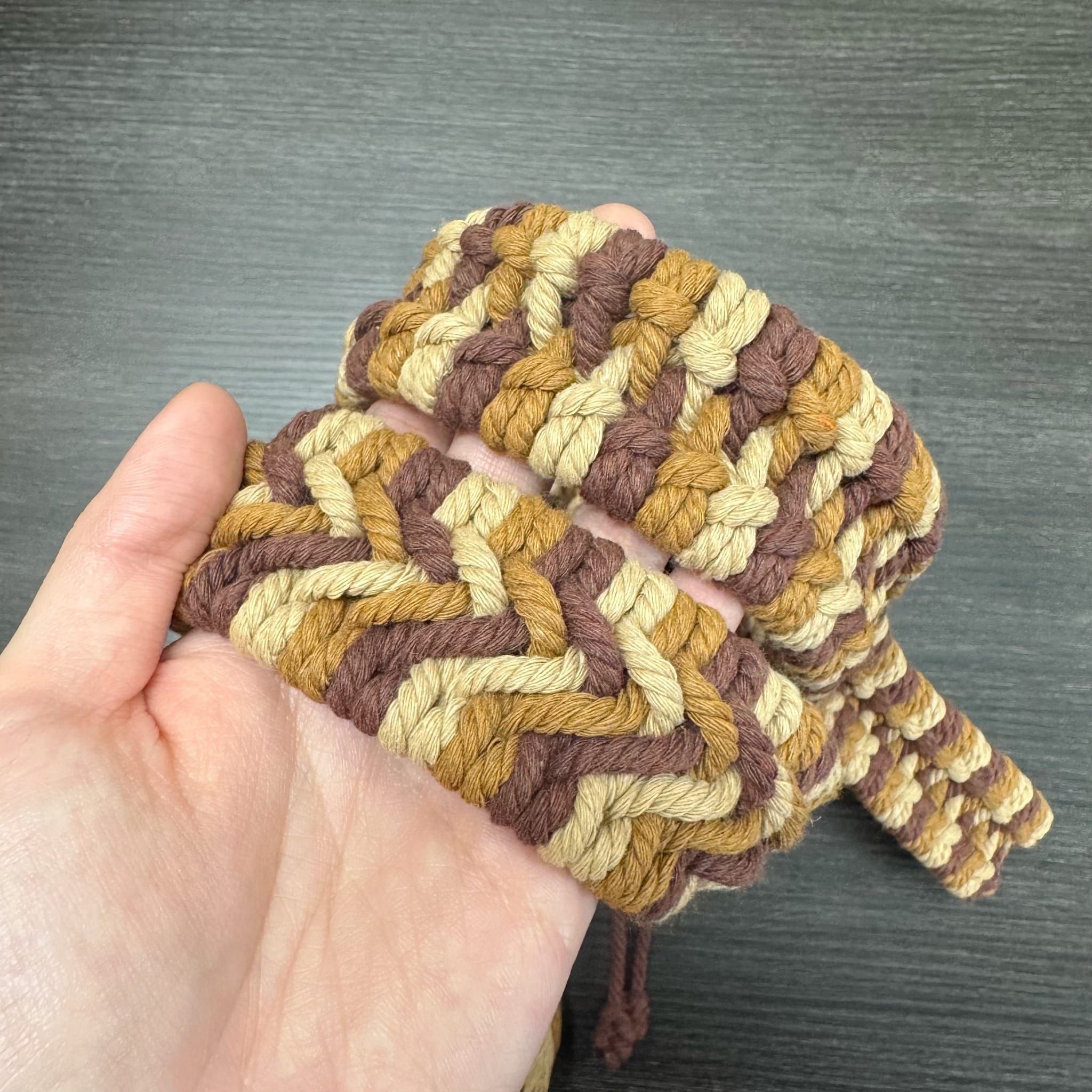 Close-up of the handwoven texture on the Harvest handpan rim braid
