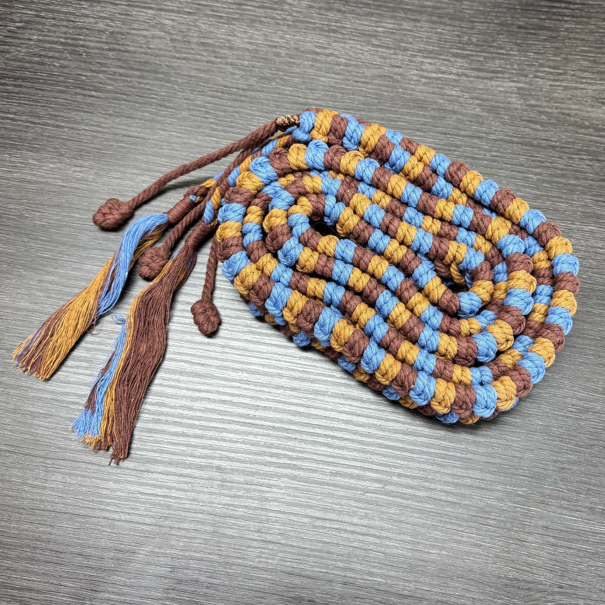 River handwoven handpan rim braid in blue, brown and golden ochre
