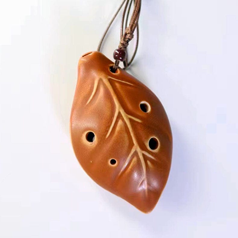 Leaf-shaped ceramic ocarina pendant with carved veins and finger holes, ideal for portable melodic play