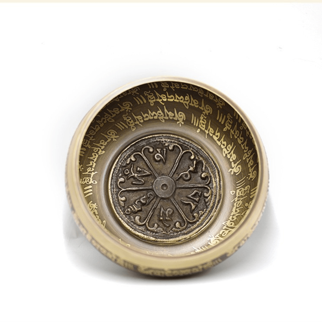 Antique bronze singing bowl with Tibetan script and mandala design, ideal for meditation and healing sound therapy.