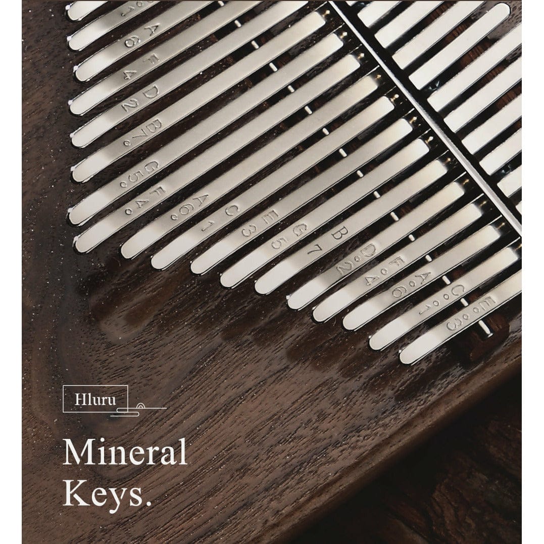 Hluru Mineral Keys kalimba with engraved metal tines on dark wood, healing musical instrument