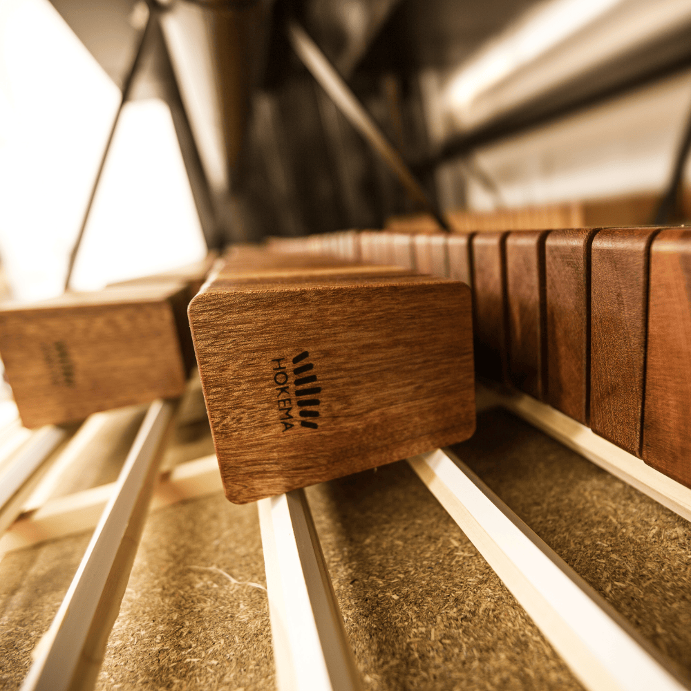 Handcrafted wooden kalimba with HOKEMA branding, showcasing rich wood grain and precise tuning keys.