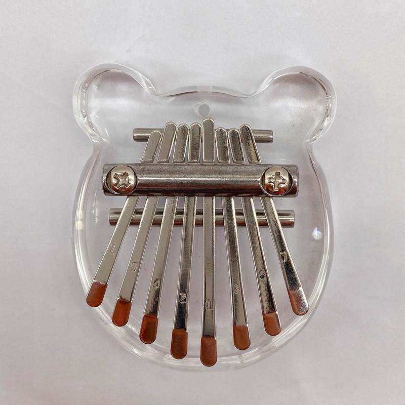 Clear bear-shaped kalimba with metal tines, perfect for beginners and healing music lovers