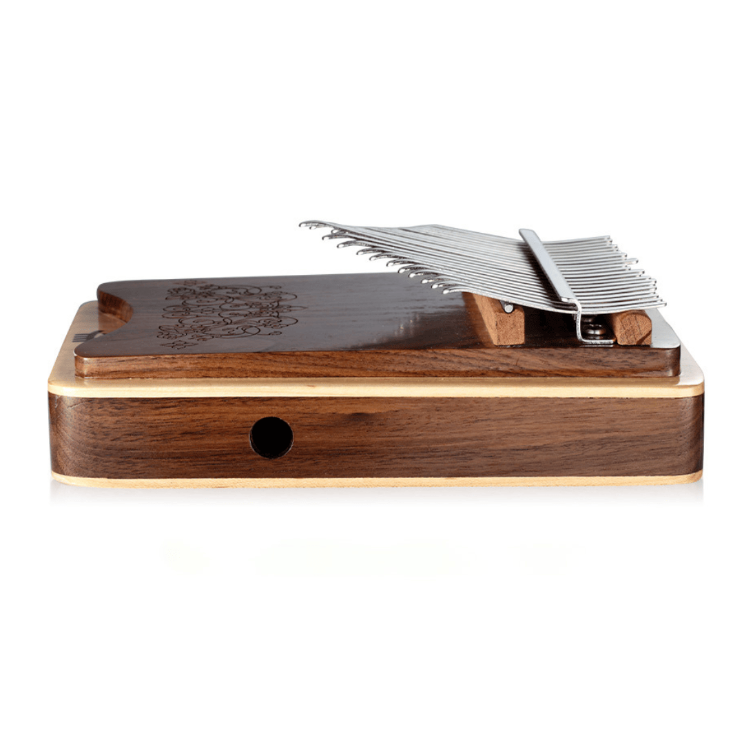 Handcrafted wooden kalimba with engraved floral design and metal tines, perfect for healing music and meditation.