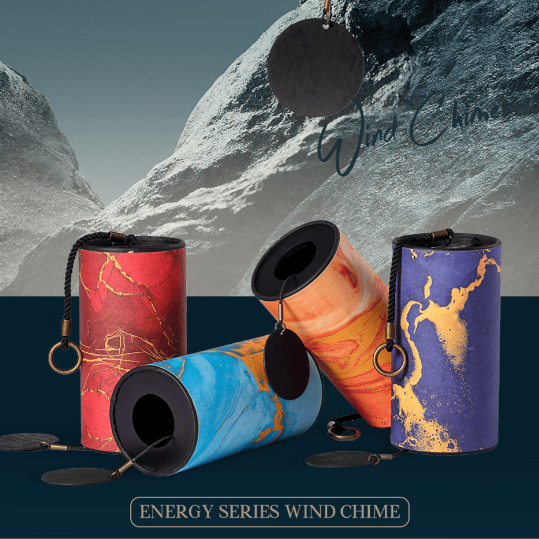 Energy Series wind chimes in red, blue, orange, and purple marble designs with gold accents, set against snowy mountains.
