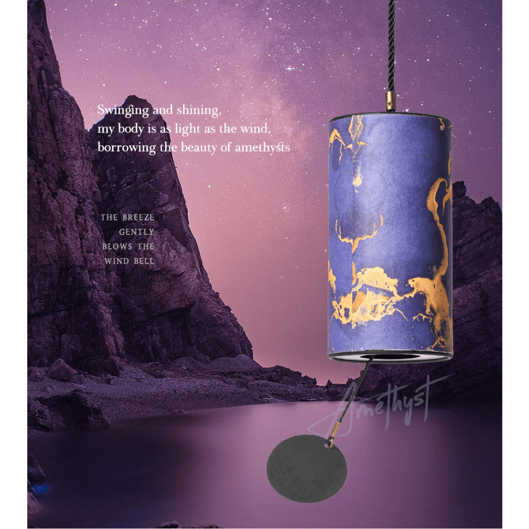Amethyst-themed wind chime with gold veining, hanging against a starry twilight sky near rocky cliffs
