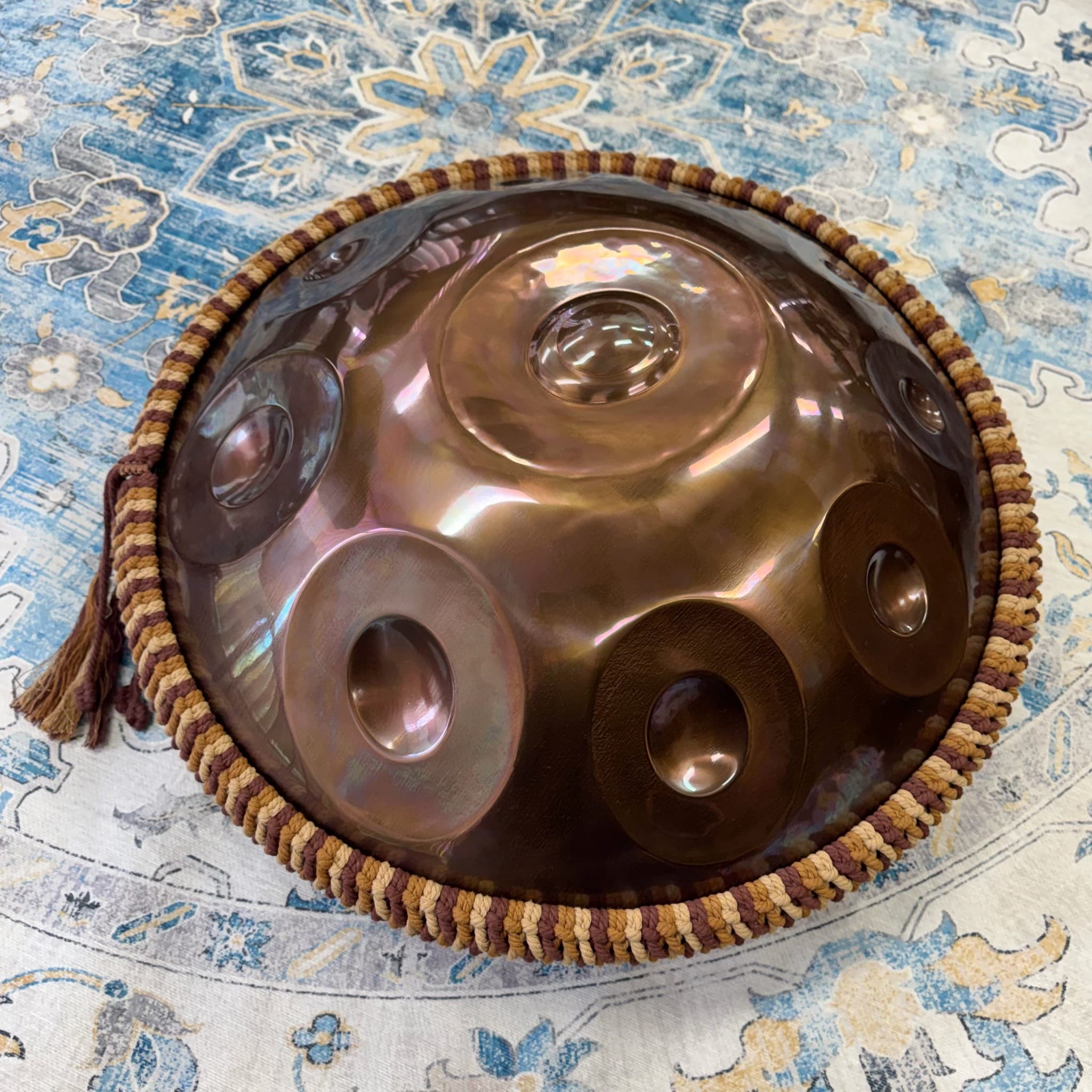 Harvest handwoven rim braid fitted around a full-size bronze handpan