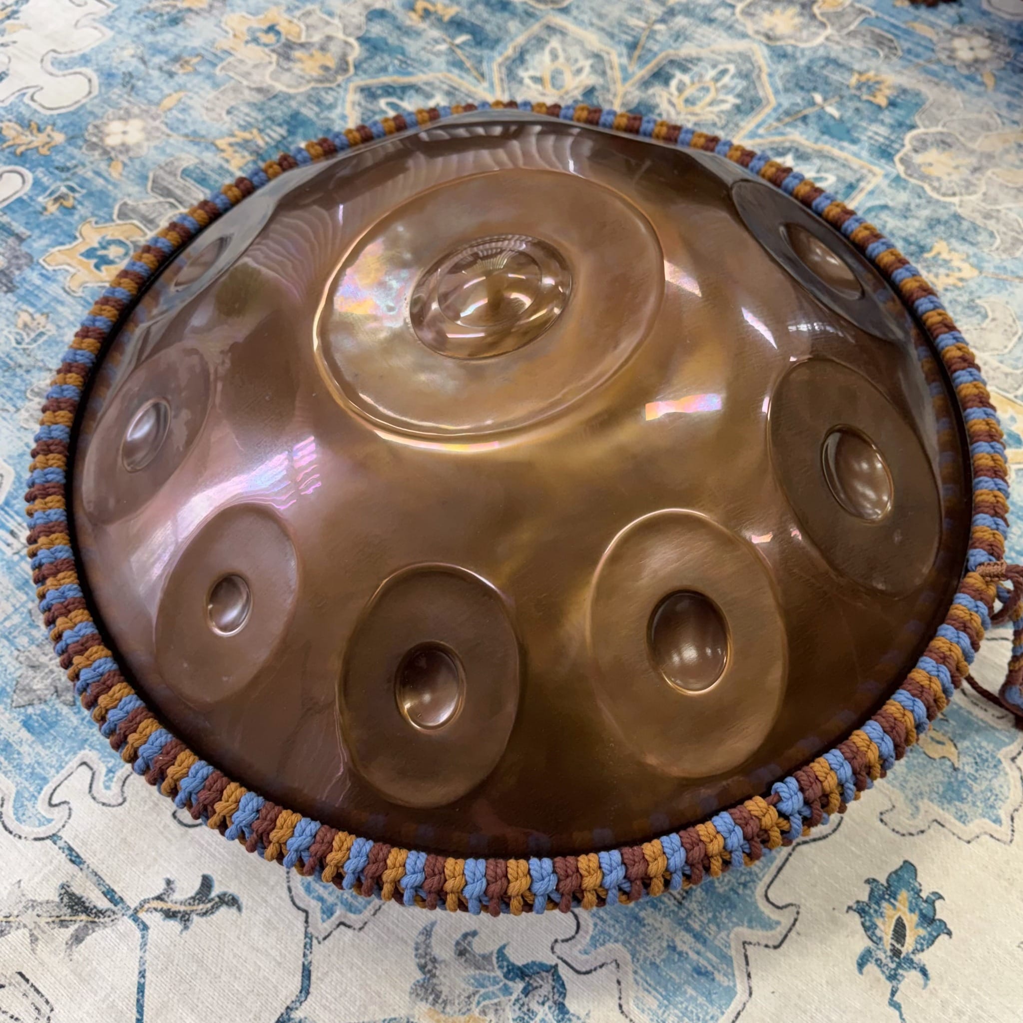 River handwoven rim braid fitted around a full-size bronze handpan