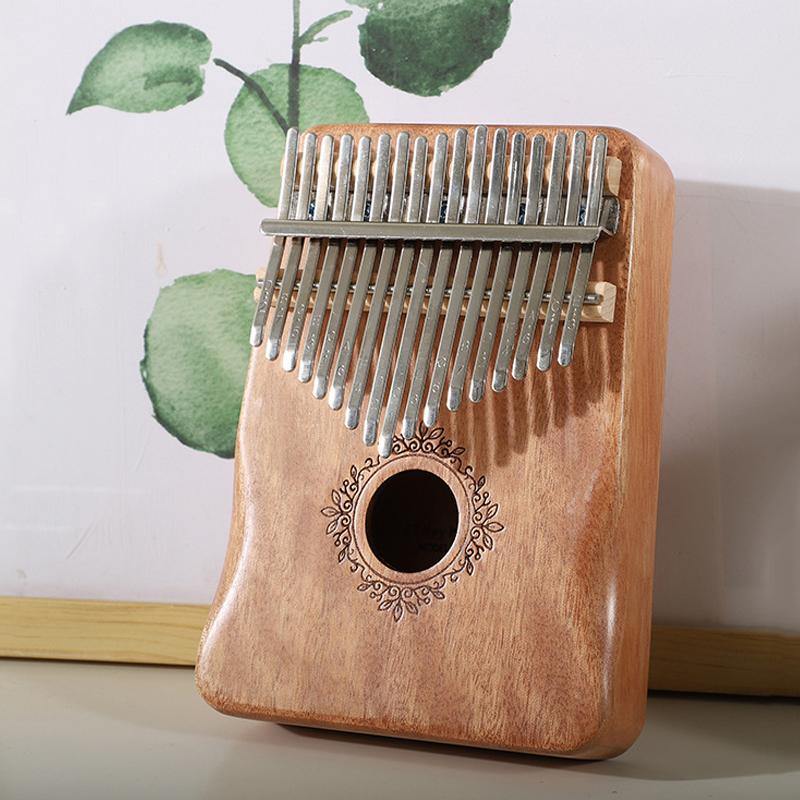 Wooden kalimba with metal tines and floral soundhole, ideal for healing music and mindfulness