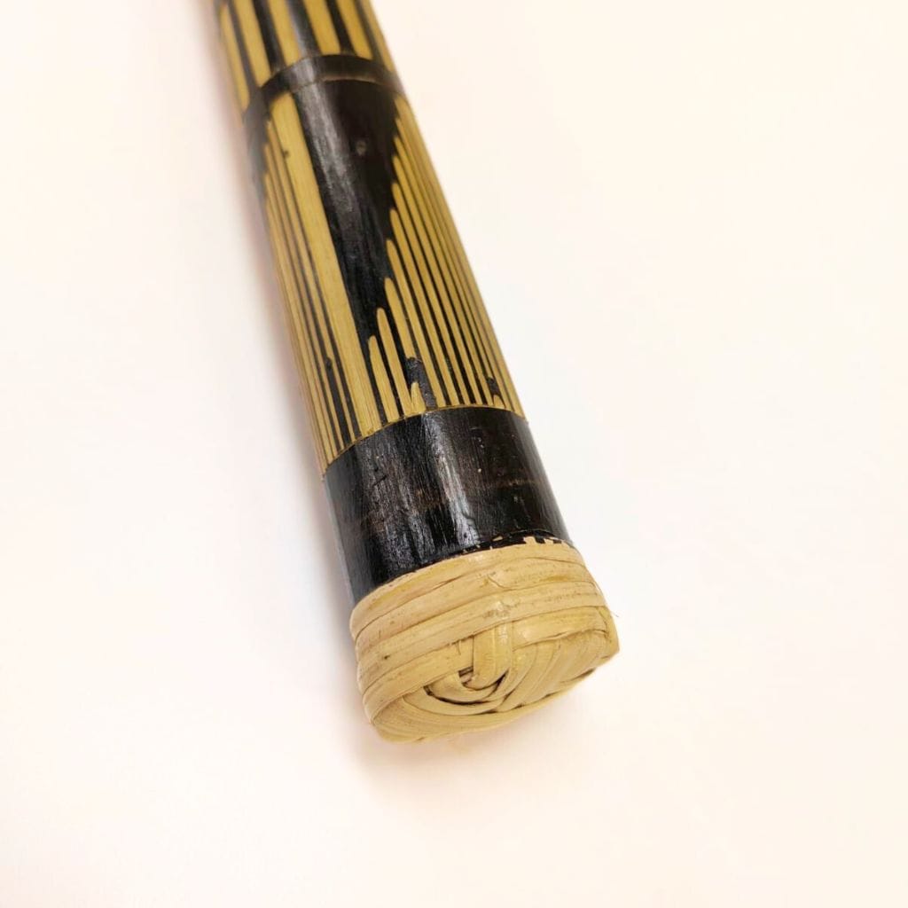 Handcrafted bamboo musical instrument with black accents and woven end, ideal for healing sound therapy