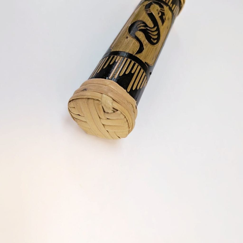 Handcrafted bamboo musical instrument with woven end and black snake design, ideal for healing sound therapy