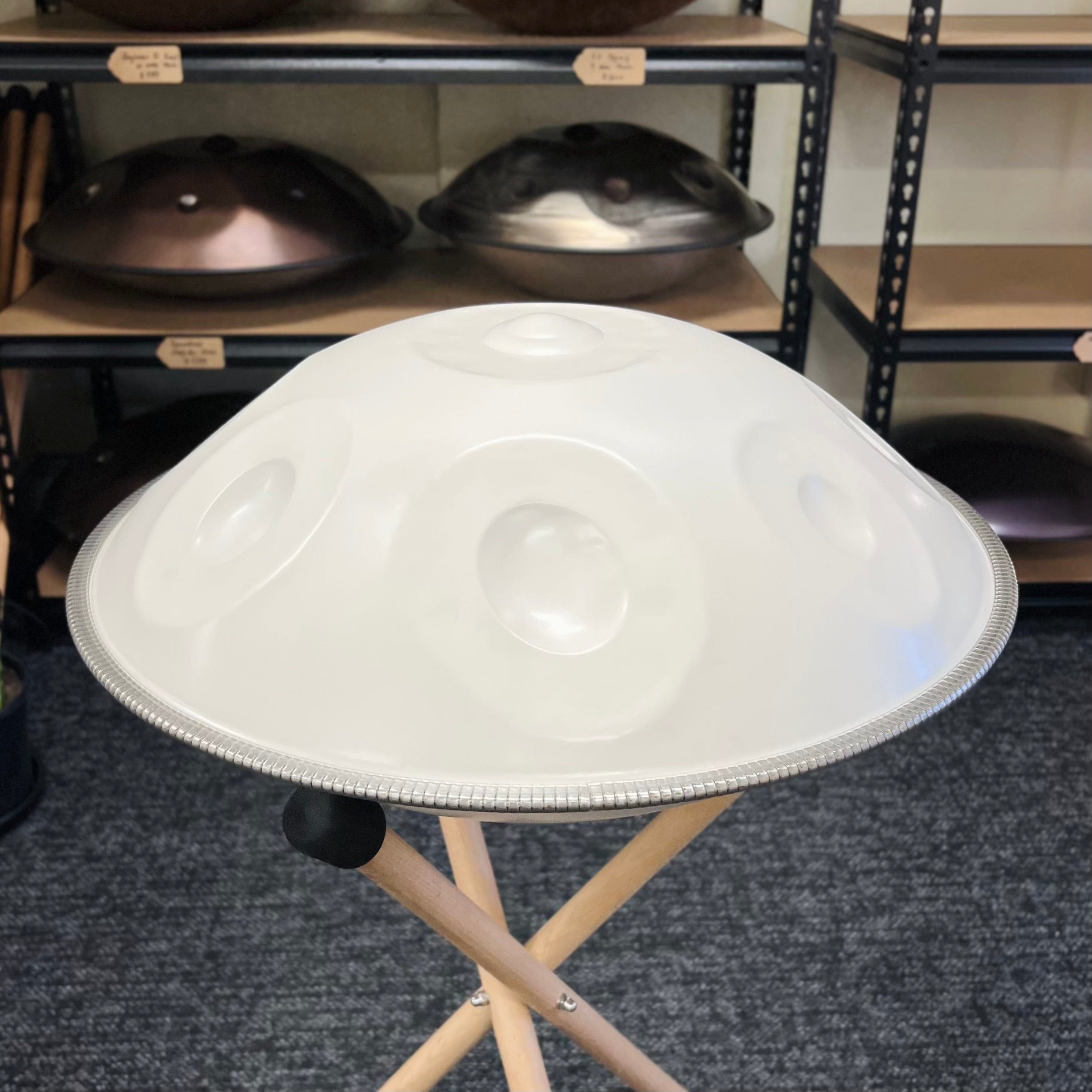 White handpan drum on wooden stand, healing musical instrument for meditation and relaxation